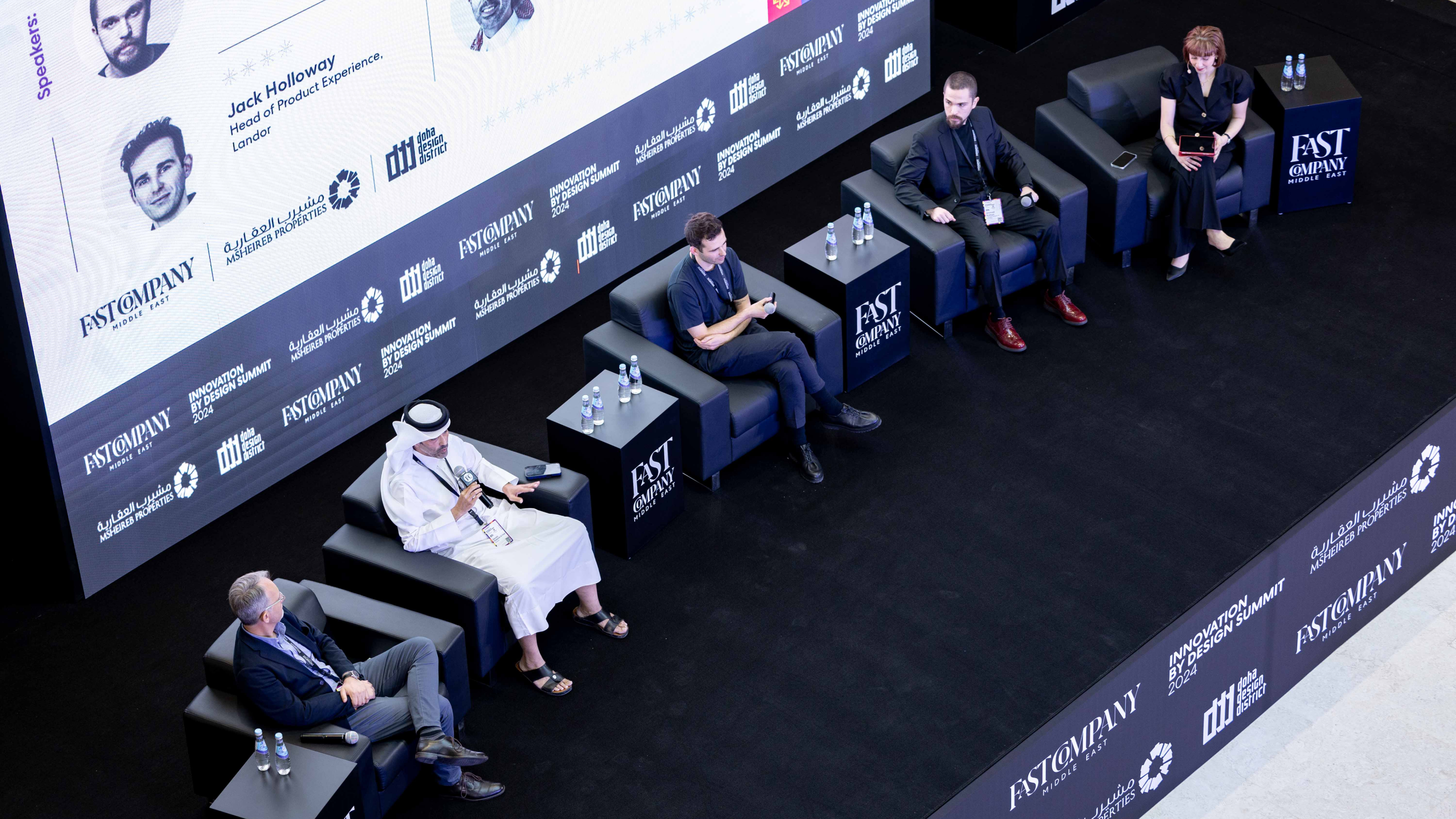 Members of a panel are seen onstage from above