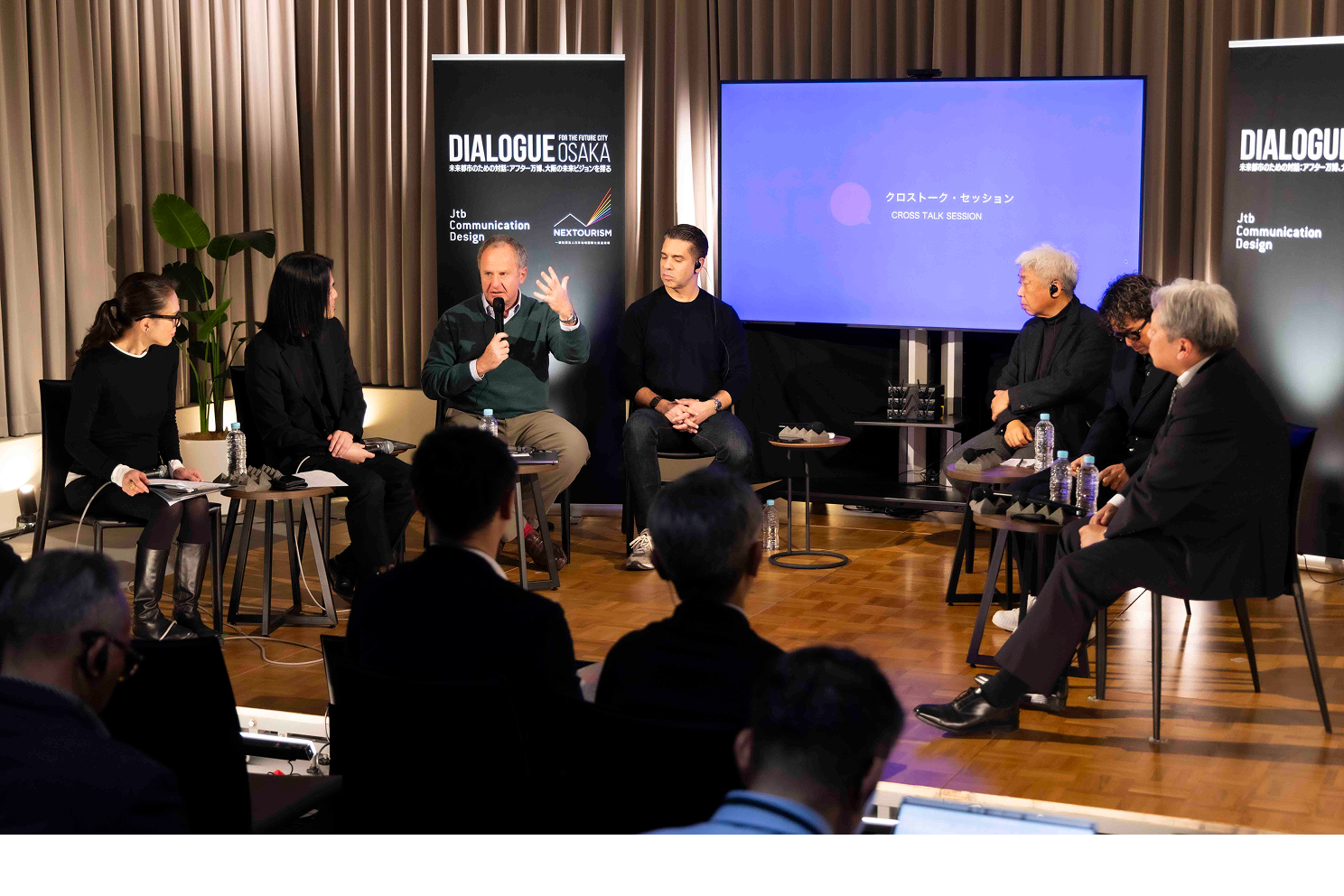 Speakers on stage at Dialogue — For the Future City Osaka, including Jacob Benbunan