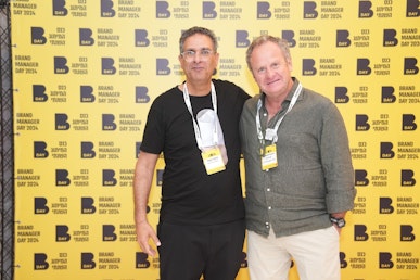 Jacob Benbunan and Yariv Amit stand next to each other at the conference